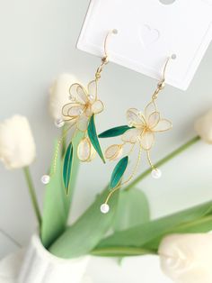 These unique handmade earrings feature a beautiful blossom flower design. Crafted from high quality materials, they make a perfect gift for the special someone in your life. Show your loved one how much you care with these stunning blossom flower earrings. Detail: - Size of earring: 60mm Material: flowers - resin; ear wires - 18k gold plated The Handmade Flower Earrings are sold in pairs of two earrings. Wire Flower Earrings, Flowers Resin, Material Flowers, Unique Handmade Earrings, Wire Flowers, Gift For Wedding, Earrings Bridesmaid, Handmade Flower, Resin Flowers