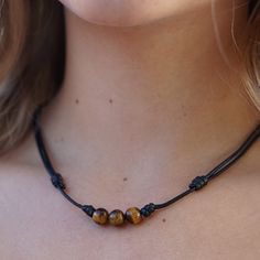 Women showcasing a Tiger Eye Choker, with the stone's distinctive golden-brown shimmer accentuating their stylish and confident look - Luck Strings Eye Meaning, Earthy Elegance, Bracelet Pack, Inner Power, Tiger Eye Beads, Beaded Choker Necklace, Inner Strength, Beaded Choker, Golden Brown