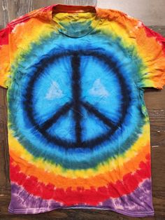 This tie dye is our Peace Sign standard. These shirts are done on Gildan brand tees and are super comfortable. Available in sizes S-2X. Please note, while most orders of our standard dyes ship next day - if your size is out of stock it will be 5-7 days for shipping. Due to the nature of tie dye, there will be slight variations in each shirt. Eye Pattern, Tie Dye Shirt, Peace Sign, Batik, Tie Dye, Rainbow, Signs, Etsy Accessories, Pet Supplies