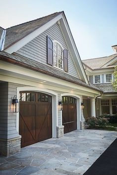 a large house with two garage doors and windows