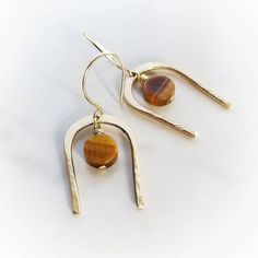 Iridescent warm brown tigers eye disc suspends from handcrafted hand forged brass. Polished & sealed with antitarnish wax to keep them bright and shiny. ~14k gold french hooks ~Wrapped and ready for gifting or keeping ~Handmade in Tennessee Modern Brown Gemstone Jewelry, Brown Drop Earrings With Ear Wire, Brown Dangle Jewelry For Everyday, Minimalist Nickel-free Brown Jewelry, Brown 14k Gold Jewelry With Gemstones, Brown 14k Gold Gemstone Jewelry, 14k Gold Brown Gemstone Jewelry, 14k Gold Jewelry With Brown Gemstones, Minimalist Brown Nickel-free Jewelry