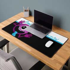 a laptop computer sitting on top of a mouse pad