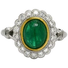 A classic Princess Diana style gemstone engagement ring. Centered by a glowing near 2 carat oval emerald with a lush, vibrant medium-dark green, complimented by a yellow gold bezel. The scalloped and milgrained 1/2 carat diamond halo adds a sparkling, fiery compliment to the rich gem. Eminently wearable with a low rise over your finger, it also has a commanding presence with a good amount of finger coverage. This would make an awesome right hand cocktail or statement ring as well.   Condition: N Reasonable Engagement Rings, Rose Gold Stackable Rings, Emerald Diamond Engagement Ring, Morganite Engagement Ring Rose Gold, Emerald Ring Engagement Diamond, Halo 2, Tanzanite Engagement Ring, Contemporary Engagement Rings, Flower Engagement Ring