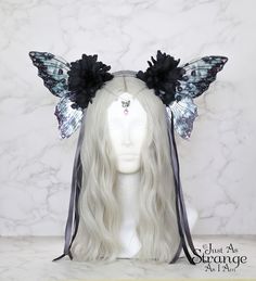 A real must-have statement crown for all fairies! A beautiful gothic black flower fairy headdress. The wings are lightweight and far more durable than their glassy appearance might suggest! They are backed with wire, which is what gives them their gorgeous curve. They are flexible to touch, and may be very slightly adjusted to give a deeper/more shallow curve. The headdress is decorated with black glowers and black and silver ribbons. Sparkling Swarovski beads and butterfly charm hang over the f Black Whimsical Headpiece For Festival, Black Whimsical Festival Headpiece, Whimsical Black Festival Headpiece, Witchy Black Headpiece For Fantasy Events, Whimsical Black Costume Headpieces, Black Fantasy Headpieces For Alternative Fashion, Black Fantasy Headband Headpiece, Whimsical Black Headpiece For Costume Party, Black Fantasy Headband