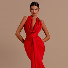 a woman in a red dress posing with her hands on her hips