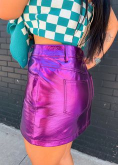 A classic purple mini skirt in our signature faux leather metallic fabric. This high waisted skirt fits like a dream and has a front fly fastening. Equally great with heels or sneakers this is set to be the perfect summer wardrobe staple! S (0-2) M (4-6) L (8-10) Purple Mini Skirt, Metallic Mini Skirt, Summer Wardrobe Staples, Metallic Fabric, Skirt Fits, M 4, Dress Romper, Band Tees, Perfect Summer