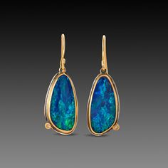 Cool, deep blues and greens shimmer in these magical Australian opals, wrapped in warm 22k gold and embellished with a tiny sparkling diamond on each earring. Earrings hang approximately 1 inch from the top of the 18k gold ear wire. Backed in sterling silver with a matte finish. These earrings will be made to order, and will ship within 10-14 business days. If you need them sooner, use the Notes section on the order form to request a rush. Studio Workspace, Crafty Jewelry, Workspace Ideas, Blue Opal Earrings, Pearl Jewelry Design, Blues And Greens, Painted Jewelry, Hand Painted Jewelry, Tourmaline Jewelry