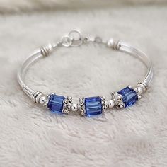 This unique, one-of-a-kind September sapphire bracelet makes the perfect gift for moms, grandmas, bridesmaids, or any special woman in your life. Gift them on birthday, anniversary, family reunion, mothers day, wedding day, anniversary and Christmas and more! ABOUT THIS ITEM: * 6mm austrian crystals * pewter bead caps * silver plated tube beads * pewter toggle * sapphire crystals are used in the photos above SHIPPING: * Processing time is 1-3 business days. RUSH ORDERS can be purchased from the September Sapphire, Mothers Bracelet, Women Jewellery, Wife Birthday, Sapphire Bracelet, Birthstone Bracelets, Blue Zircon, Bracelets For Women, Perfect Gift For Mom