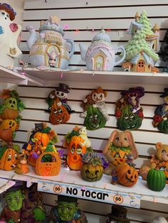 there are many halloween decorations on the shelves