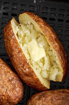 two breads with butter on them sitting on top of a black grill grate