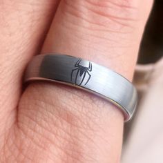 a person wearing a spider man ring on their finger