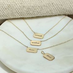 14k gold rounded rectangle disc necklace with a name of your choice engraved in lowercase script, "mama" pictured SPECIFICS • 14k tiny cable chain adjustable at 16-17-18"• pendant tag is approx. 13mm x 6.4mm• available with up to 6 characters• please note all engraving will be done in lowercase letters for this piece Classic Everyday Customizable Necklaces, Classic Everyday Customizable Necklace, Personalized 14k Gold Necklace For Everyday, Elegant 14k Gold Hand Stamped Necklaces, Elegant 14k Gold Necklace Hand Stamped, Elegant 14k Gold Necklace With Hand Stamped Details, Dainty Personalized Square Pendant Necklaces, Dainty Personalized Square Pendant Necklace, Personalized 14k Gold Filled Necklaces As Gifts