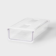 a plastic container with two compartments on the top and one in the bottom, sitting against a white background