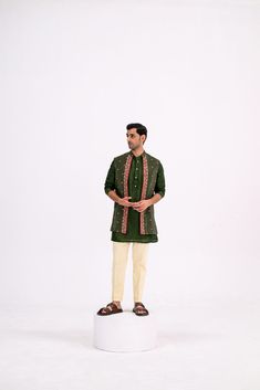 This chic set features a green dotted kurta, sleek pants, and a heavy half jacket for a bold, sophisticated look. Perfect for formal or festive occasions, the combination of the kurta and structured half jacket brings a modern edge to traditional wear. Festive Designer Green Outerwear, Green Traditional Semi-formal Sets, Green Festive Outerwear For Festivals, Green Straight Kurta Bandhgala With Dabka, Green Straight Kurta Bandhgala With Dabka Details, Green Zari Work Outerwear For Eid, Designer Green Cotton Sherwani, Green Outerwear With Zari Work For Eid, Eid Designer Wear Nehru Jacket In Green