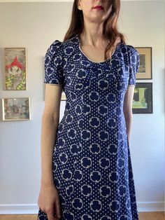 This body skimming vintage 70s geometric maxi dress is divine. So So Vampires Wife (style) with nods to prairie and cult dresses.  * Navy Blue & White, geometric print  70s vintage maxi / prairie dress  * Tie waist gives a lovely fit and the lightweight fabric skims the body  * Sweetheart neckline with white piping detail (and at sleeve hems)  * Concealed zip @ back  * Original Vintage Labels attached  Excellent condition some very minor yellowing on the neck and arm piping, expected with age. T Fitted Square Neck Lined Maxi Dress, Vintage Blue Printed Dress, Retro Short Sleeve Dress With Vintage Pattern, Blue Fitted Retro Vintage Dress, Vintage Printed Short Sleeve Dress, Fitted Patterned Printed Maxi Dress, Fitted Patterned Maxi Dress, Vintage Fitted Patterned Dress, Vintage Fitted Printed Dresses