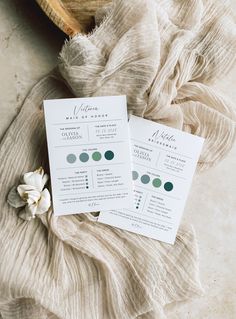 two wedding programs sitting on top of a table