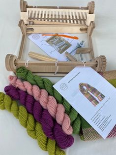 several skeins of yarn sitting on top of a table next to a knitting machine