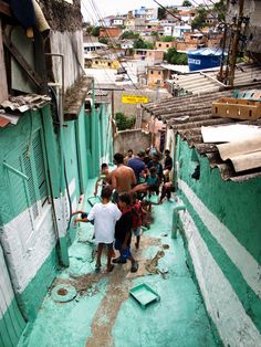 a group of people walking down a narrow alley way