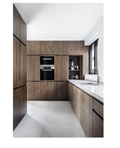 a kitchen with wooden cabinets and white counter tops