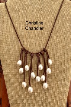 This is a very elegant piece of Pearl and Leather Jewelry. The leather is a deep Red Brown and is 18 inches and has 12 hanging pieces of diverse lengths falling from it, and each strand ends with a large oval Freshwater Pearl that is 12-15mm of high quality. The longest strand in the middle falls 3 inches off the 18 inch necklace. The clasp on the back is a beautiful button pearl, making the back as elegant as the front. This necklace is an excellent addition to any type of wardrobe. Dress it up Elegant White Leather Jewelry, Elegant Brown Leather Jewelry, Elegant Adjustable Leather Necklaces, Elegant Leather Necklace For Formal Occasions, Luxury White Leather Jewelry, Handmade White Leather Jewelry, Leather Necklace For Gifting, Classic Leather Jewelry For Anniversary, Elegant Single Strand Brown Pearl Necklace