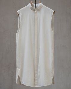 A summer top designed to stand-alone as a paradoxically refined sleeveless shirt, as an over-layer to elevate any t-shirt, or as an interlocking compliment the Chronos Mid-sleeve. Fabricated in a luxurious organic Japanese cotton that utilizes high-twisted yarns to achieve a shirt that's as light as it gets while staying strong enough to age well for decades. The shirt features a unique architectural side vent + seaming, extremely fine construction techniques, minimal collar, and a hidden placke Sleeveless Relaxed Fit Shirt For Spring, Relaxed Fit Sleeveless Shirt For Spring, Summer Cotton Tops With Curved Hem, Modern Spring Shirt For Layering, Modern Shirt For Spring Layering, Fitted Summer Tops With Curved Hem, Fitted Summer Top With Curved Hem, Summer Tops With Relaxed Fit And Curved Hem, Fitted Summer Tops With Shirttail Hem