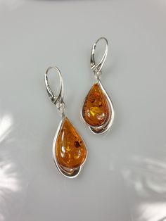 Welcome to my handmade shop. Item description: Sterling silver 925 earrings with Amber and all hallmarks. Length: 5 cm This item was made of natural Baltic Amber. All the amber used in my jewelry is collected in my home country Lithuania. I sell only genuine, real, not pressed, authentic, natural Baltic Amber. Item may have natural imperfections. Due to amber being natural, each of my jewelry is unique and even the same models can be slightly different. Please contact me for more details, photos White Gold Teardrop Earrings With Polished Finish, Hallmarked White Gold Drop Earrings, Fine Jewelry Sterling Silver Teardrop Earrings, Nickel-free Classic Teardrop Earrings For Anniversary, Polished Teardrop Drop Earrings For Anniversary, Nickel Free White Gold Drop Earrings, Nickel-free White Gold Drop Earrings, Sterling Silver Earrings With Polished Finish For Anniversary, Sterling Silver Polished Earrings For Anniversary