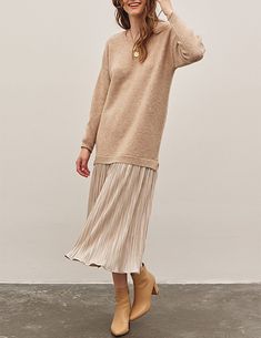 Updating a vintage silhouette with soft detail, the Luisa dress artfully combines the perfect slouchy, longline sweater with a sweeping plisse skirt at the hemline. A soft + plush biscotti knit and crinkle drop-waist skirt in shimmery champagne - this elevated sweater dress is ideal for holidays with suede ankle boots or lifted by a nude heels. 74% acrylic, 22% polyester, 4% spandex 100% polyester lining Unlined top, lined skirt Dropped shoulders Pullover fit Very relaxed fit, consider sizing do Twofer Top, Dress With Ankle Boots, Twofer Sweater, Skirt And Sweater, Drop Waist Skirt, Longline Sweater, Metallic Pleated Skirt, Metallic Skirt, Vintage Silhouette