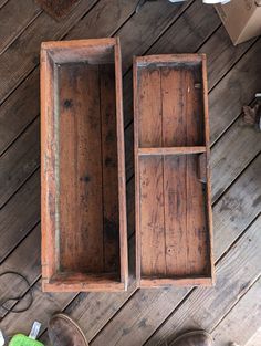 two wooden boxes sitting on top of a wooden floor next to shoes and other items