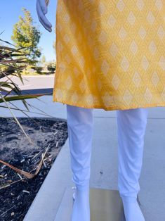 Premium quality Yellow Color Silk Men's Kurta Pajama Set with design pattern all over the Kurta. The neckline has lace work and fancy buttons. Item : Men's Kurta PajamaReady to Wear : YesPocket : YesKurta Color : Yellow Pajama Color : Cream/White Fabric : SilkLining : Yes Work : Fancy buttons, Woven Zari work, Lace WorkPattern : DesignerDisclaimer-For sizing please refer to the Size Chart given in the listing with the pictures.- Please do NOT go by the size of the Kurta that you already have fro Traditional Bottoms With Printed Motifs For Eid, Traditional Fitted Pants With Printed Motifs, Fitted Traditional Pants With Printed Motifs, Traditional Pants With Printed Motifs For Festivals, Traditional Yellow Pants For Festive Occasions, Eid Cotton Bottoms With Dabka Detailing, Traditional Yellow Pants For Summer, Traditional Yellow Bottoms For Festive Occasion, Traditional Straight Kurta In Cotton