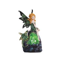 a fairy figurine sitting on top of a green and black planter next to a white background