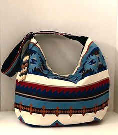 Beautiful colorful Erika Hobo Bag will put you center stage wherever you go. The geometric tribal design has colors of blue, brown, cream and black. The body of the bag measures approx. 15" H x 17" W and hangs approx 30" from top of strap to bottom of bag. Our bag is fully lined in our signature black quilted fabric, has inside pocket, magnetic closure and beaded hang ornament. Hand wash, Hang or lay flat to dry. Visit our shop https://www.etsy.com/shop/JNINGfashion? Visit our custom T-Shirt shop at www.etsy.com/shop/WordupTreasures Everyday Use Handheld Blue Canvas Bag, Blue Large Capacity Crossbody Canvas Bag, Large Capacity Blue Canvas Crossbody Bag, Blue Handheld Shoulder Bag For Everyday, Handheld Hobo Bag With Handles For Travel, Blue Handheld Shoulder Bag For Daily Use, On-the-go Hobo Bag With Adjustable Strap, Multicolor Handheld Shoulder Bag For Errands, Blue Handheld Shoulder Bag For Travel