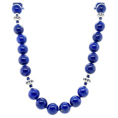 This gorgeous necklace of round lapis lazuli beads with sapphire and white gold accents is the epitome of style and sophistication! 10mm round, beautifully matched lapis with their high-polish and stunning royal blue color have been arranged with 18k white gold rondels, faceted blue sapphire beads and white gold rondels. The larger white gold rondels are set with tiny sparkling sapphires that complement the lapis perfectly, and the white gold accents have a lovely stardust finish, treating your Crystal Bracelets Diy, Sapphire Beads, White Gold Necklace, Artisan Bracelets, Lapis Lazuli Beads, Azul Real, White Gold Necklaces, Royal Blue Color, Ring Pendant Necklace