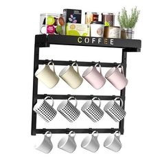 a shelf with coffee cups and mugs hanging from it's sides on the wall