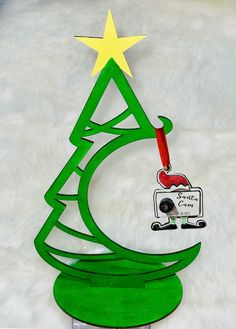 a green christmas tree with a yellow star on top and a radio in the bottom