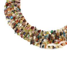 a multi - colored beaded necklace is displayed on a white surface