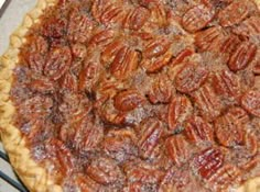 a pecan pie sitting on top of a metal rack