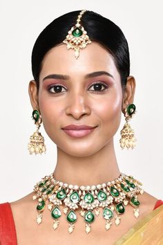 Gold toned necklace with green enamel detailing and kundan stone embellishments. Comes with a pair of matching jhumkas and maangtikka. - Aza Fashions Green Stone Work Bridal Necklace, Green Hand-set Kundan Necklace, Hand Set Green Kundan Necklace, Green Meenakari Jewelry For Formal Occasions, Formal Green Meenakari Jewelry, Green Kundan Bridal Necklace, Green Meenakari Necklace For Formal Occasions, Formal Green Meenakari Necklace, Green Jeweled Kundan Necklace