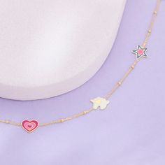 This magical unicorn charm bracelet is fit for a princess! Featuring multi-colored enamel on each of its charms, this bracelet is a happy burst of color that will brighten up any outfit. Made from 14k yellow gold, a material safe for sensitive skin, this bracelet measures 5 inches with an additional 1-inch extension, making it adjustable to fit her small wrist. The unicorn charms add a touch of whimsy to the bracelet, making it adorable for any little girl who loves all things magical. Give the Playful Multicolor Jewelry With Removable Charms, Playful Pink Jewelry With Removable Charms, Playful White Jewelry With Charms, Playful Pink Enamel Jewelry, Playful Star Charm Jewelry For Gifts, Playful Jewelry With Star Charm For Gift, Playful Multicolor Jewelry With Star Charm, Playful Pink Jewelry With Star Charm, Unicorn Bracelet