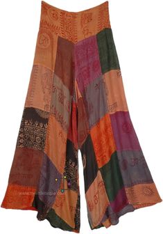 Add a pop of hippie spiritual and free style to your pants collection with these handmade patchwork pants inspired by spiritual prints (Om, Krsna, Hare Rama, etc)! Made with soft, flowy, and breathable organic cotton, these pants feature a bright orange color scheme with unique patchwork designs that are sure to turn heads. The wide legs offer a flowy and comfortable fit, perfect for bohemian and hippie-inspired styles. #tlb #SplitSkirtsPants #Patchwork #BohemianPants Hippie Style Yoga Pants, Hippie Style Cotton Bottoms With Patchwork, Hippie Wide Leg Bottoms For Festivals, Hippie Wide Leg Festival Bottoms, Bohemian Cotton Yoga Pants, Hippie Multicolor Harem Pants For Festivals, Cotton Hippie Wide Leg Yoga Pants, Hippie Wide Leg Cotton Yoga Pants, Hippie Style Patchwork Harem Pants For Festivals