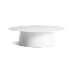 a white round table on a white background with no people in the room around it