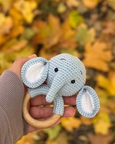 a person holding an elephant toy in their hand