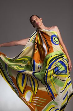 "Printed silk Pareo or a big silk scarf? This Luxurious accessory can be both!  Dikla Levsk'y \"LA FAMA\" scarf is printed with vibrant colors and an abstract figure of a woman wearing a silk scarf.  This playful piece made from 14mm Italian twill silk, can be wrapped around the waist and tied in a knot. It can also be worn over the shoulders as a shawl or dress. Don't be afraid to clash colors and patterns! This scarf makes a perfect addition to your wardrobe that will serve you well on so many vacations. Size: 140×140 cm / 55×55 inch 100% 14 mm twill silk >Made in Italy >Dry clean >Gift box included *color and pattern may appear slightly different on your screen* All rights reserved to Dikla Levsky." Big Silk Scarf, Luxury Silk Scarves, Designer Scarf, Luxury Scarves, Square Silk Scarf, Scarf Dress, Printed Silk Scarf, Designer Scarves, Bold Style