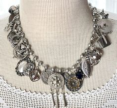 From a once loved, large collection of vintage jewelry, including necklaces, bracelets and earrings, I have gleaned all these silvery components to create a stunning assemblage necklace.    This is a fully loaded collection of interesting components that have a lovely weight and sound.  The silvery-gray pearlized glass bead chain is 18" long. I work with vintage and antique parts. Some may show some signs of wear or age. Please look at the pictures carefully, and contact me before purchasing if you have any questions. I can send additional pictures if you prefer. I like to think that older items possess a character that newer items have not yet earned. Vintage Metal Jewelry With Vintage Charm, Victorian Vintage Charm Metal Jewelry, Bohemian Vintage Charm Jewelry For Wedding, Bohemian Wedding Jewelry With Vintage Charm, Vintage Metal Jewelry With Dangling Charms, Vintage Antique Silver Dangle Jewelry, Antique Silver Vintage Dangle Jewelry, Vintage Silver Necklace With Dangling Charms, Antique Metal Jewelry With Vintage Charm