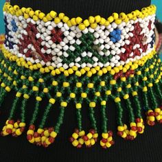 a close up of a colorful beaded necklace on a mannequin headdress