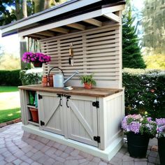 an outdoor kitchen with potted plants on the outside