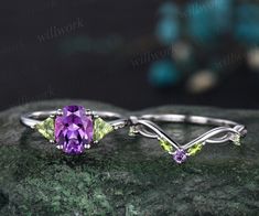 - Metal: Solid gold(10K/14K/18K white/yellow/rose gold),925 sterling silver,platinum available- Main Stone: 7x9mm oval cut natural amethyst- Accent Stone: 4mm trilliant cut natural peridot- Wedding Band Stone: amethyst and peridots- Band Width: 1.4mm- Can be personalized: Yes Amethyst Wedding Ring Set, Purple Three Stone Wedding Jewelry, Oval Amethyst Three Stone Wedding Ring, Gold Unique Engagement Ring, Amethyst Wedding Band, Amethyst Wedding, Moissanite Ring Set, Topaz Birthstone, Ring Three Stone