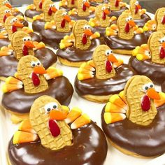 chocolate covered donuts decorated like turkeys and sitting on top of eachother