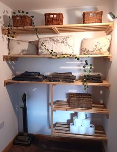 the shelves are filled with various items and baskets on them, including toilet paper rolls