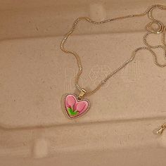 Trendy Pink tulip flower heart shaped pendant charm necklace, 14K real gold plated chain. Crafted from high-quality materials, this stunning necklace features a delicate heart-shaped pendant adorned with a beautiful pink tulip motif, symbolizing love, beauty, and new beginnings. Cute girly aesthetic, y2k layering necklace choker. Exquisite statement necklace to elevate your fashion style. 💎 Features: ♥ Handmade jewelry ♥ Finish Tone: Finest 14K gold plated | Pink ♥ Approximate Measurements: - L Pink Heart-shaped Jewelry With Clavicle Chain, Pink Heart-shaped Clavicle Chain Jewelry, Pink Heart Necklace With Clavicle Chain For Valentine's Day, Valentine's Day Pink Heart Necklace With Clavicle Chain, Trendy Rose Gold Flower Shaped Jewelry, Trendy Gold Plated Heart Charm Necklace, Trendy Gold Plated Heart Necklace With Heart Charm, Trendy Gold Plated Heart Necklace, Pink Flower-shaped Necklaces For Mother's Day