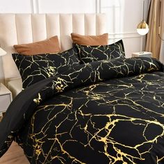 a black and gold marbled comforter set on a bed